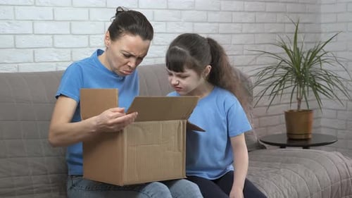 Mother and Child Express Disgust with Mystery Box