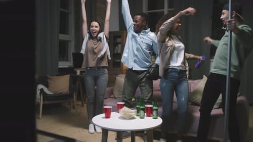 Excited Friends Cheer for Sports Team at Home