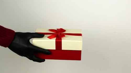 Festive Gift Exchange with Hands in Gloves