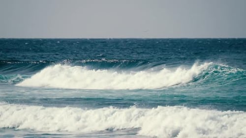Big blue wave splash near the beach in the ocean - summer vibes and vacation concept