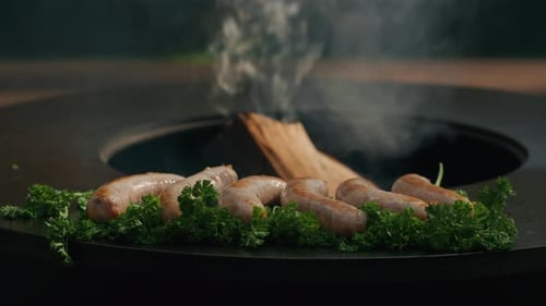 Meat Sausages Browning on Grill Outdoors