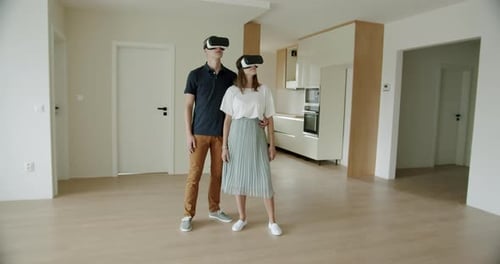 Couple Experiencing Virtual Reality in Modern Apartment