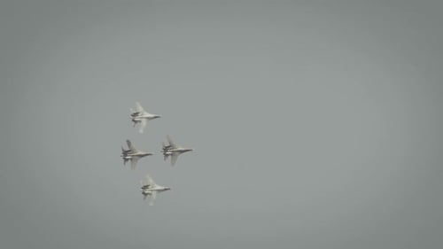 Planes Fly in Formation Through Overcast Sky