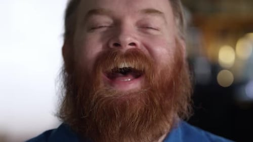 Close up view of mans face as he chuckles