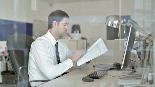 Ambitious Middle Aged Businessman Working on Office Computer and Read Documents