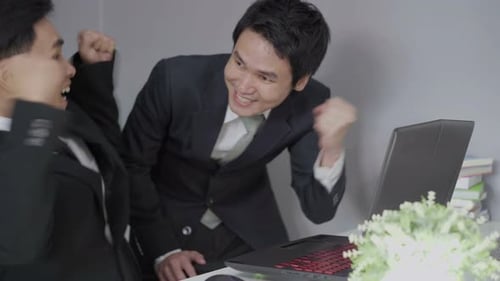 Business Team Celebrates Success at Computer