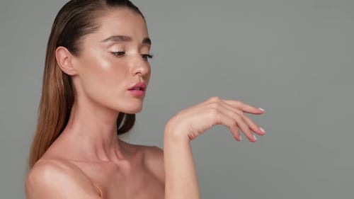 Woman Posing with Hand Raised in Studio