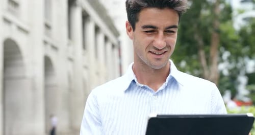 Young Man Using Tablet in City Environment