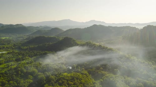 Flying through the clouds above the mountain peak.