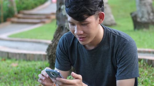 Man Using Phone At The Park