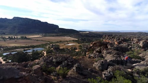 Male rock climber walking over a rocky mountain 4k