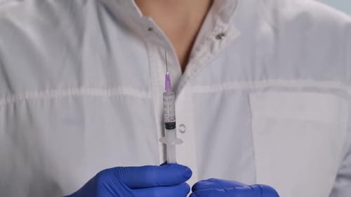 Medical Worker Prepares Syringe Injection