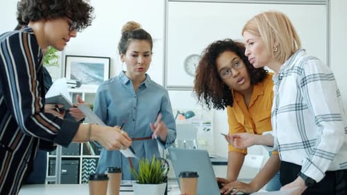 Women Collaborate in Modern Office Environment