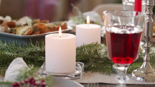 Festive Christmas Dinner Table with Candles and Food