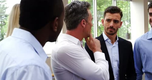 Professionals Discuss Business in an Office Environment