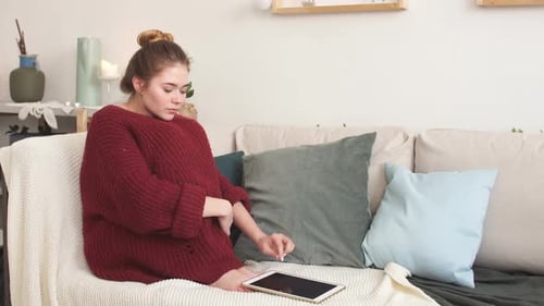 Young Adult Woman Using Tablet at Home