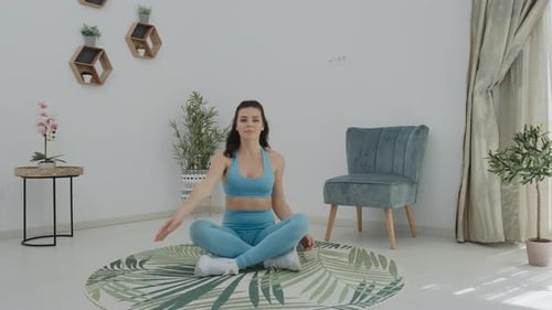 Woman Stretching Arms While Sitting at Home