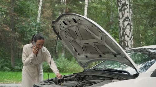 Woman With Car Trouble Talks on Retro Cellphone