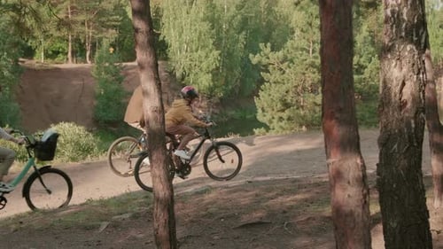 Family Cycling Together In Park