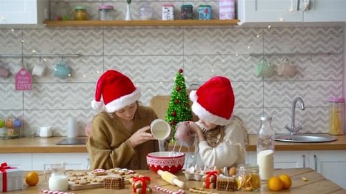 Girls Baking Christmas Cookies Together in Kitchen