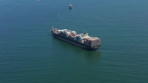 Aerial Top View of Cargo Ship Carrying Container and Running with Tug Boat for Export Goods From