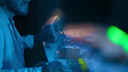 Technician Repairs Electronics in High-Tech Lab