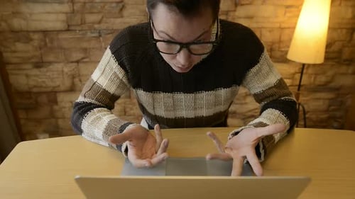 Young Man Typing on Laptop Computer at Desk