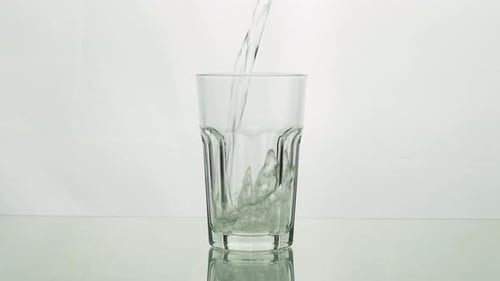 Water is poured into a clear glass
