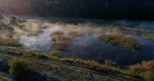Drone Aerial View Beautiful Lake Covered with Fog Near Forest at Sunrise