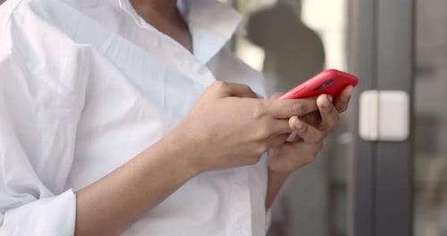 Hands Using Red Cell Phone Close Up