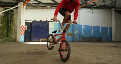 BMX rider in an empty warehouse