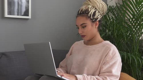 Young Woman Working on Laptop at Home
