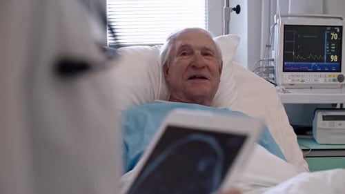 Senior Man Receiving Healthcare in Hospital Bed