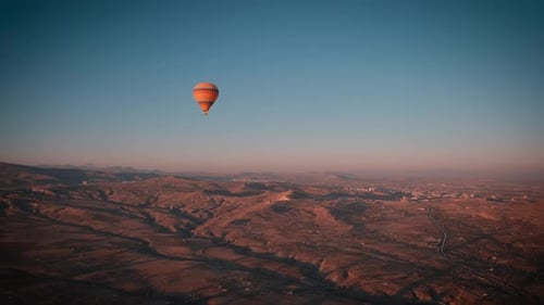 Hot Air Balloon Over Desert at Sunrise