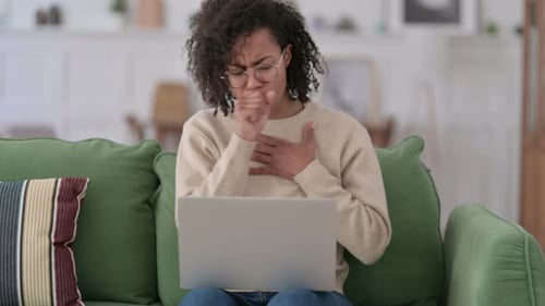 Woman with Curly Hair Coughing on Laptop
