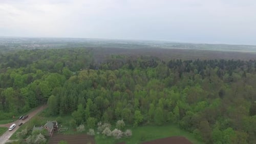 Aerial View of Small Country City and Surrounding Forest Landscape