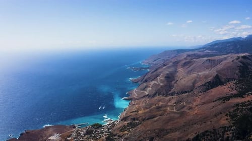 Aerial view of Mediterranean Sea. Flying above mountain near Coast in Hora Sfakion, Crete, Greece.