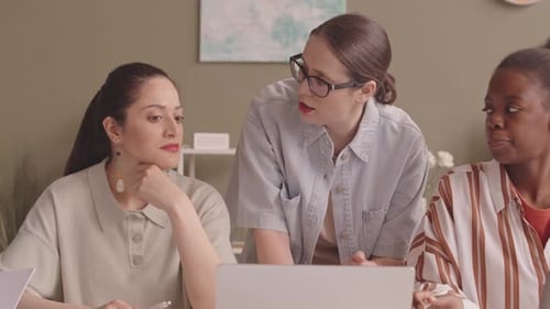 Female Colleagues Having Discussion at Office Meeting