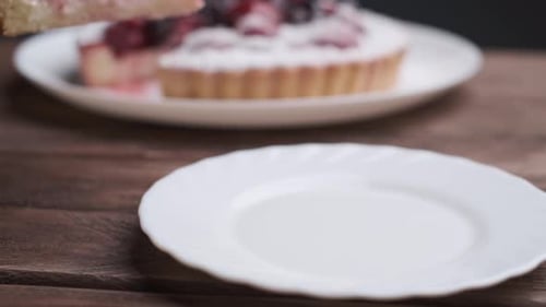 Putting a Slice of Berry Pie on Plate