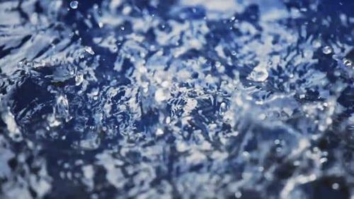 Abstract Water Droplets Rippling on Blue Surface