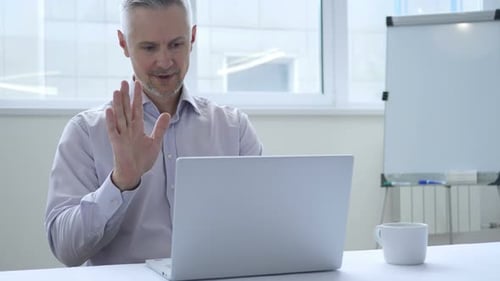 Man Working on Laptop in Bright Office