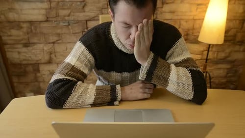 Stressed Young Adult Looking at Computer
