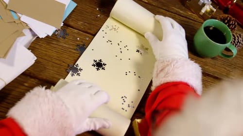 Santa Checking Christmas List at Wooden Table