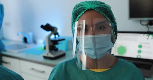 Young female nurse after work inside hospital during coronavirus period