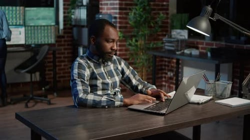 Financial Analyst Looking at Laptop with Exchange Market Sales