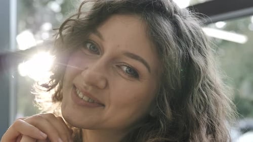 Smiling Woman Portrait with Curly Hair and Natural Light