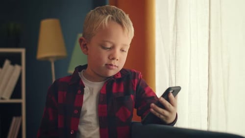 Cute Child Using Smartphone at Home