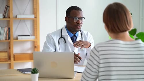 Doctor Consulting with Patient in Office Setting