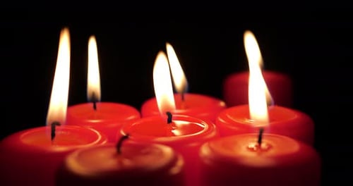 Red Christmas Candles Being Lit Up One by One on a Black Background in Time Lapse