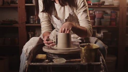 Pottery Workshop Female Hands Smoothening the Sides on the Pot Using a Tool